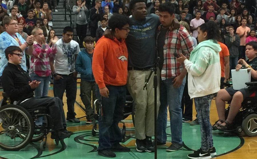 Greeley West students Isiah Roman and Lorenzo Balderrama help guest speaker Timothy Alexander to his feet at an assembly on Thursday, August 25.  