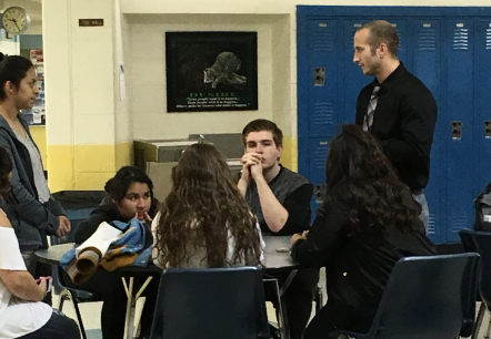 New counselor Mr. Mitch Johnson works with AVID students in the commons on Tuesday.  