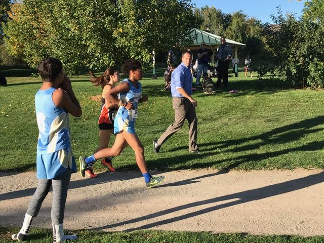 Maria Geesaman runs in front of her coach at the City Championship meet on Wednesday.