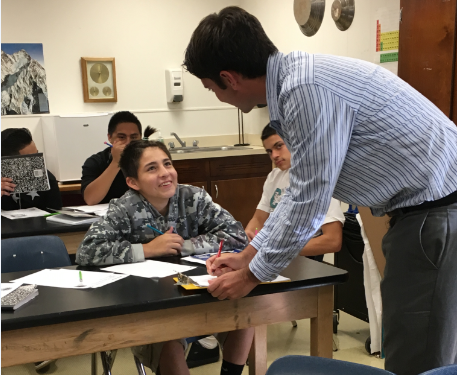 Mr. Ryan Pace pauses his lesson to help Mario Garcia during class on Wednesday. 