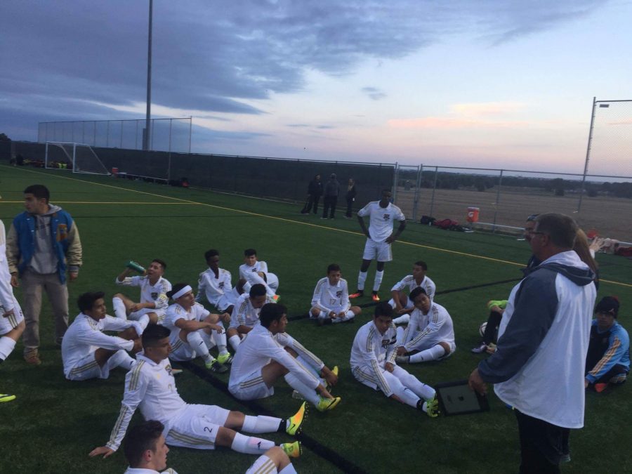 The boys soccer team listens to a halftime speech on Tuesday, September 13 at District 6 Stadium.  