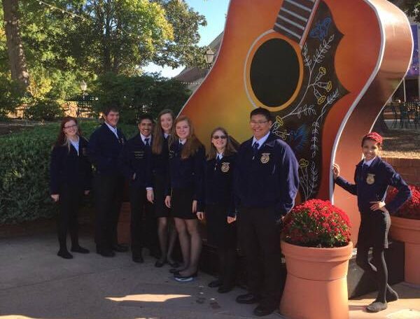 Greeley West FFA students pose in front of a giant guitar at the Grand Ol Opry in Nashville.  