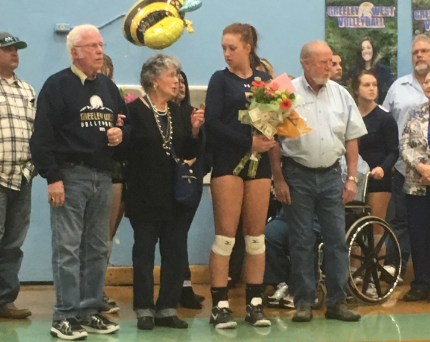 Senior Ryan Maderra walks with her family before her final home game at Greeley West High School.