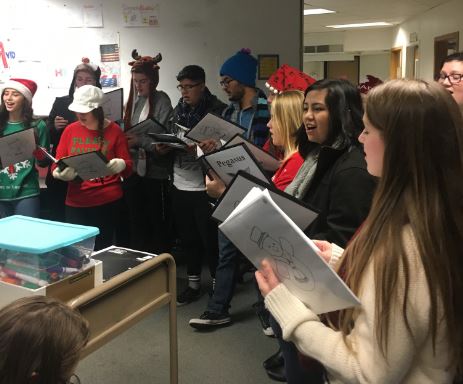 Greeley Wests Pegasus choir serenades a computer lab full of students. 