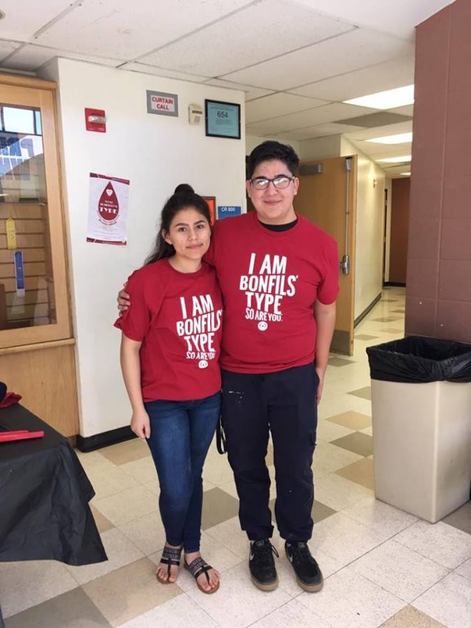 Jorge Jacquez and Abby Lujan show off their fancy blood drive T-shirts.