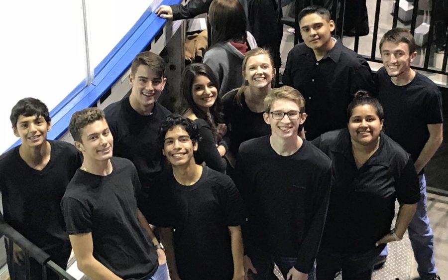Greeley West choir members stand along the ice, waiting for their opportunity to perform the National Anthem at the Colorado Eagles game.  
