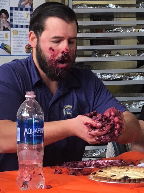 McAdams stuffs his face with mashed up blueberry pie during a pie-eating contest. 