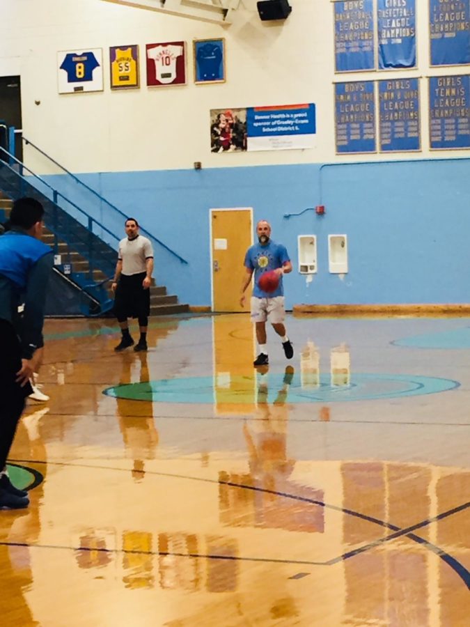 Mr.+Brandon+Torrez+walks+the+ball+back+up+court+during+the+alumni+basketball+game.++