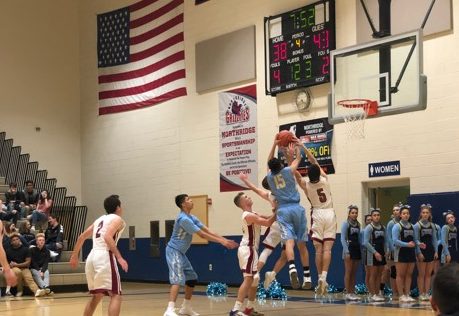 Senior Oscar Flores jumps for a rebound against Northridge on Saturday night while junior Tommy Gonzales watches.  