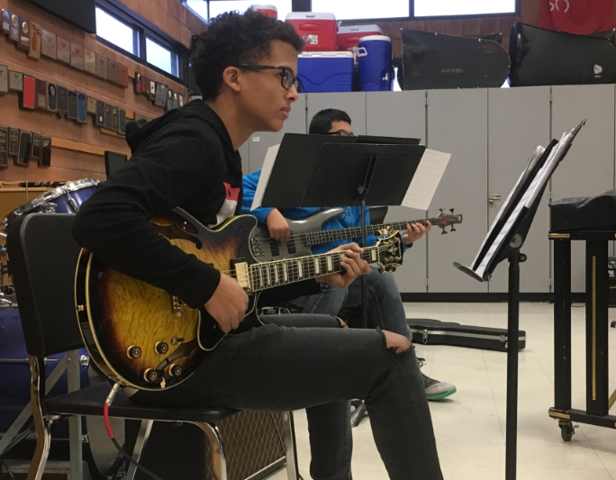 Liam Garcia jams on the electric guitar.