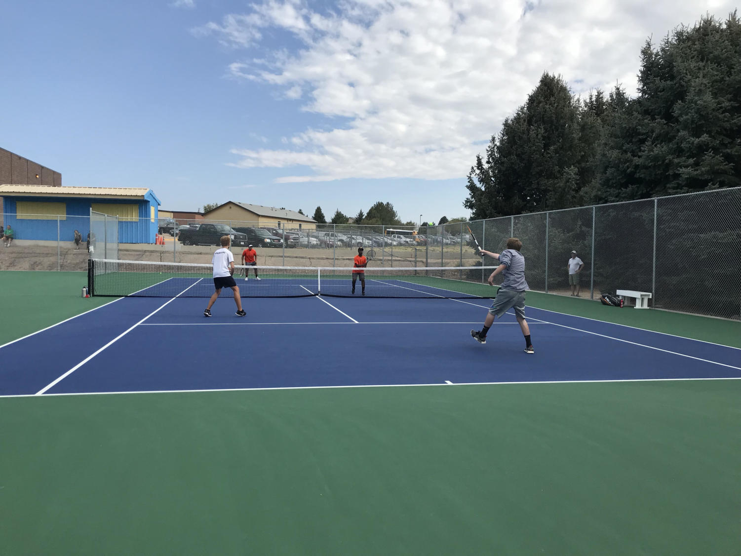 Brayden Startzer, right, is making an impact as a player on the Greeley West tennis team, despite having never played before.