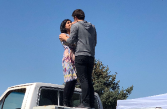 Denver Center for the Performing Arts actors embrace on top of a white pick up truck during their performance of Romeo and Juliet in Greeley Wests parking lot on Wednesday.  