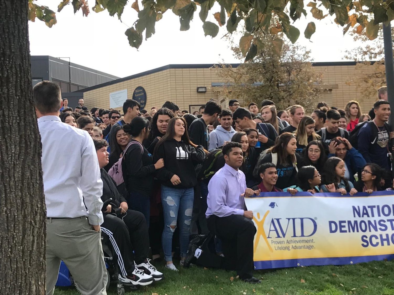 Greeley West principal Mr. Jeff Cranson works to organize AVID students for a picture after it was announced that the school maintained its Demonstration School status.