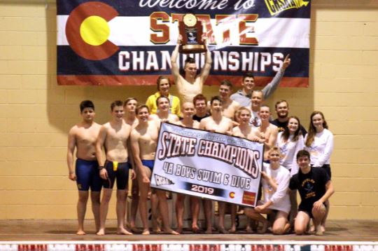 The Greeley West boys swimming team celebrates their championship in a team photo.  