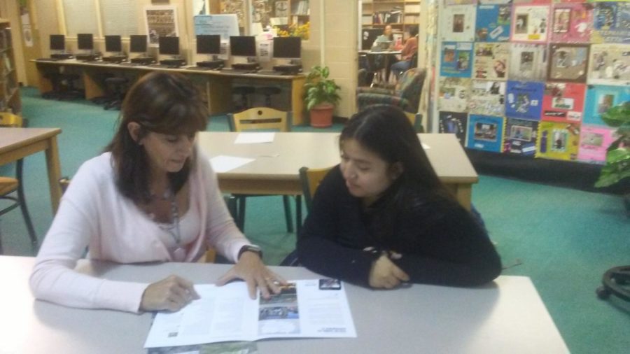 Ms. Susan Eastin and Daniela Adame Salomon discuss a future trip abroad in the library last week.  