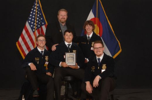 Greeley West Ag teacher Mr. Kelly Longacre stands with his national-qualifying students for a picture.  