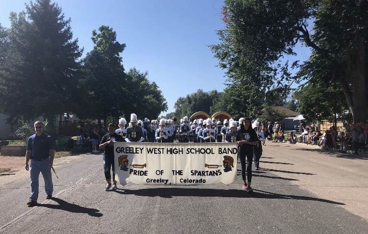 The Greeley West marching band performs in motion during the Evans Heritage Parade on Saturday.  