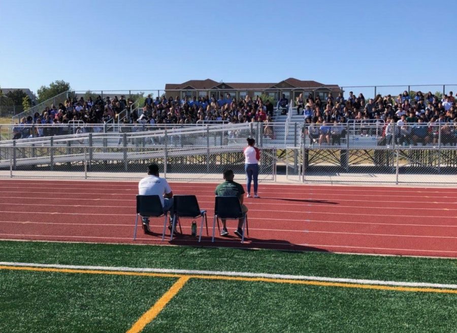 Greeley+West+AVID+students+sit+on+the+bleachers+on+the+football+field+listening+to+guest+speaker+Ivanna+Rizo+share+stories+about+college+and+how+AVID+helped+her+get+there.++