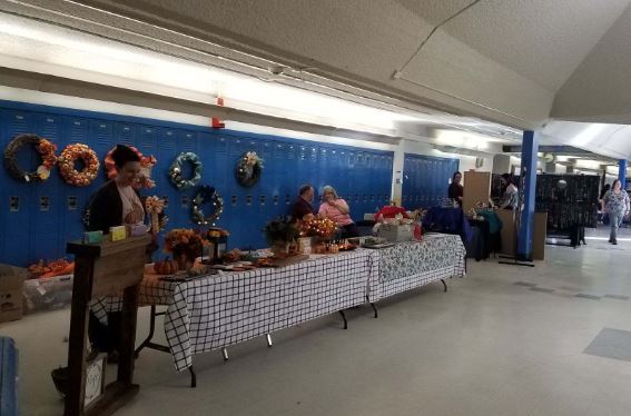 Craft vendors line the hallways of the commons for the holiday craft fair that was sponsored by the Greeley West Booster Club. 