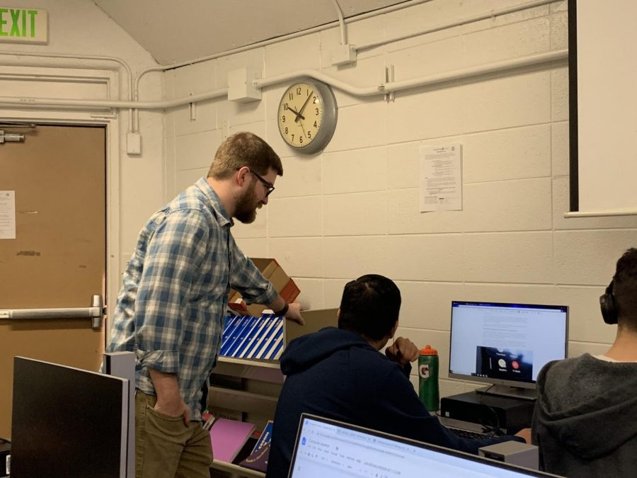 Science teacher Taylor Plantt helps a student during class this week.  Plantt and his fellow science teachers have a distinct style.