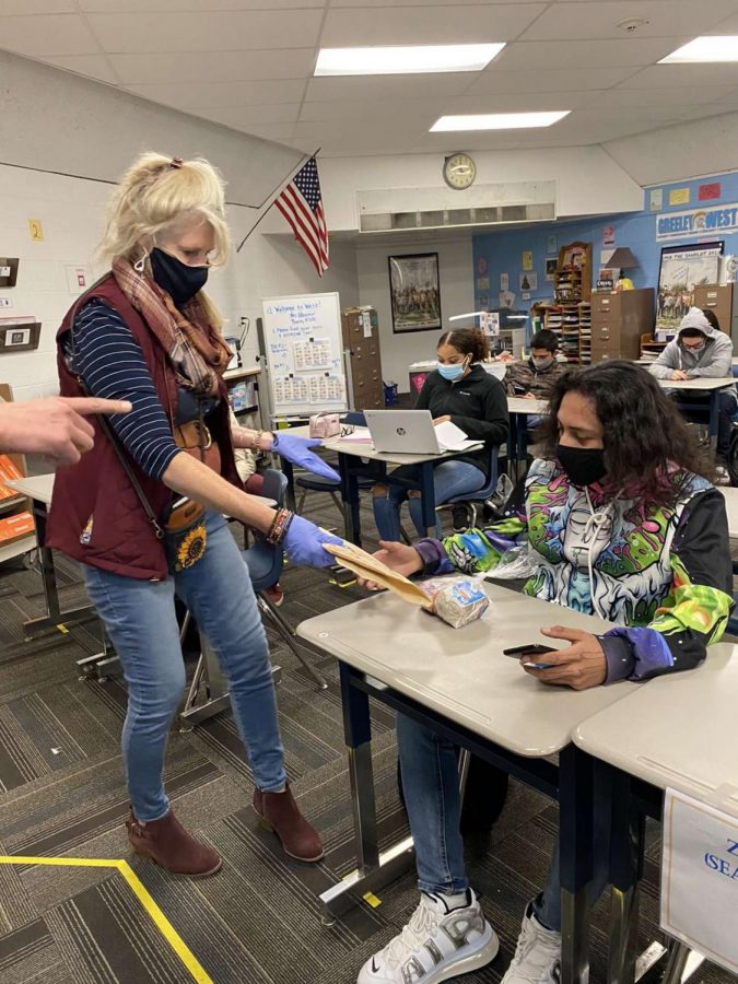 Ms. Rachel Hammer distributes lunch to her students on Friday afternoon.  One of the big changes in school during Covid-19 has been how students get their mid-day meal.