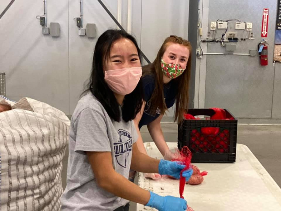 University High School students Anna Bedell and Kaelan Graznak volunteer for the Success Foundation last year.  West students can still find plenty of ways to reach out to their community in 2021.