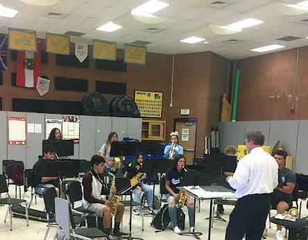 Band director, Mr. Chet Arthur, guides the GWHS band in a socially distant rehearsal space. Arts students continue to be impacted by COVID-19 protocols. 
