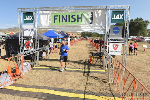 Mr. Tom Nugent triumphantly runs through the finish line at the Fall Equinox Marathon.