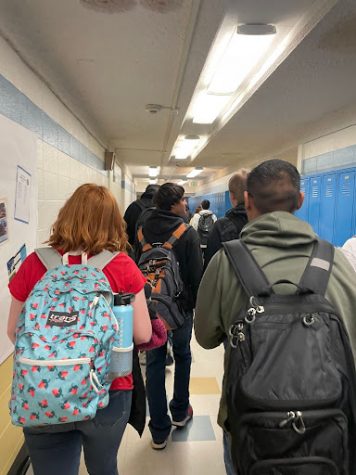 Greeley West students walk down the hall, backpacks over their shoulders.  West instituted a new policy that tries to keep backpacks on campus and out of the community. 
