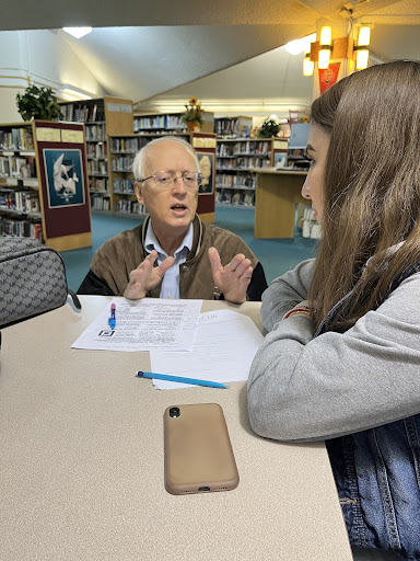 Ruby Chavez Ramirez receives extra help from Mr. Peter Jakus. 