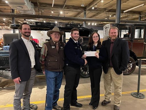 Greeley West agriculture student, Tucker Hurley is being awarded this grant check alongside his teacher, Mr. Kelly Longacre.