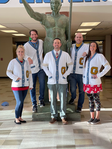 The Greeley West administrative team poses in their fashionable letter sweaters. 