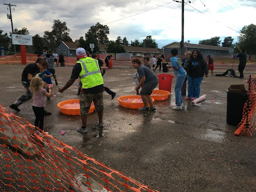 Teenagers gathered and participated in a water balloon fight at this cool back to school barbecue I went to.  