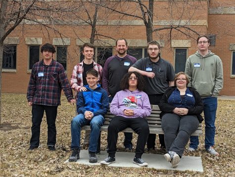 Members of the College Physics class pose for a picture in front of a science lab at Colorado State University. 