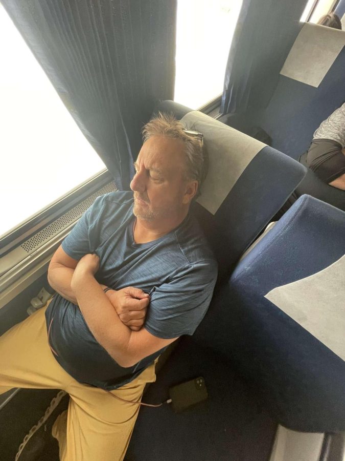 Greeley West baseball coach Jim Jorgensen rests his eyes on the train ride from Denver to Grand Junction last week.  