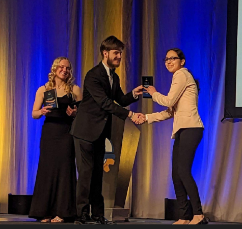Greeley West senior Jovanny De La Rosa accepts here award at the State FBLA competition.  De La Rosa is on her way to compete at Nationals in Atlanta. 