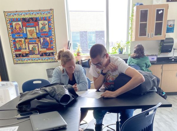 Ms. Marka Latif works with a student in her classroom earlier this week.  In addition to being a new teacher at West this year, Latif is a surrogate mother for a family in London. 