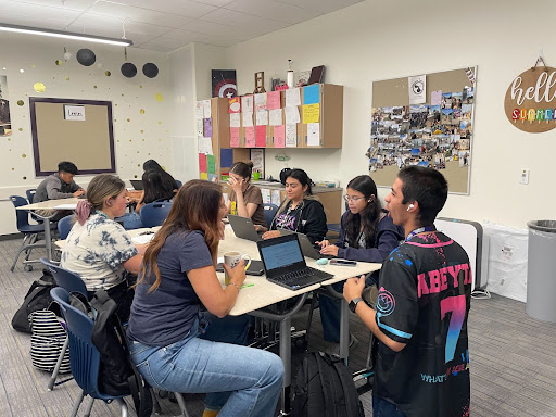 Memers of the Greeley West Yearbook class discuss page designs for this years new annual. 