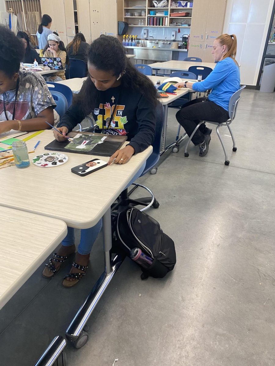 Senior Firtuna Tensu works on an art project during class on Friday afternoon.  Tensu fled Eritrea for the better life she has found at Greeley West.  