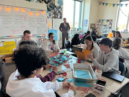 The Greeley West student council attaches notes to candy canes as part of their year-ending event.  Presdient John F. Kennedy looks on with approval.
