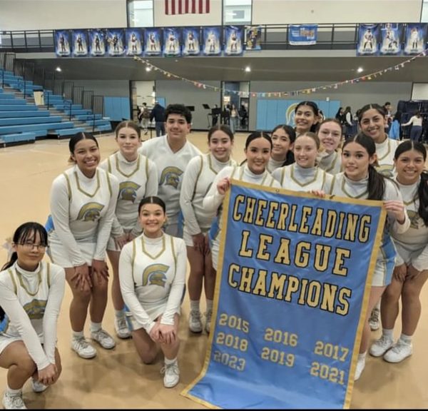 The Greeley Wset cheerleades pose with their banner last week.  