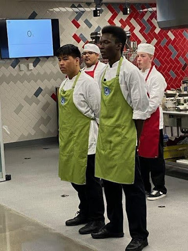Seniors Aydin Fermin and Omari Edwards watch as their meal is judged at the One Plate Challenge in Cherry Creek.  Results are quarantined until June, but the students were proud of their effort.  