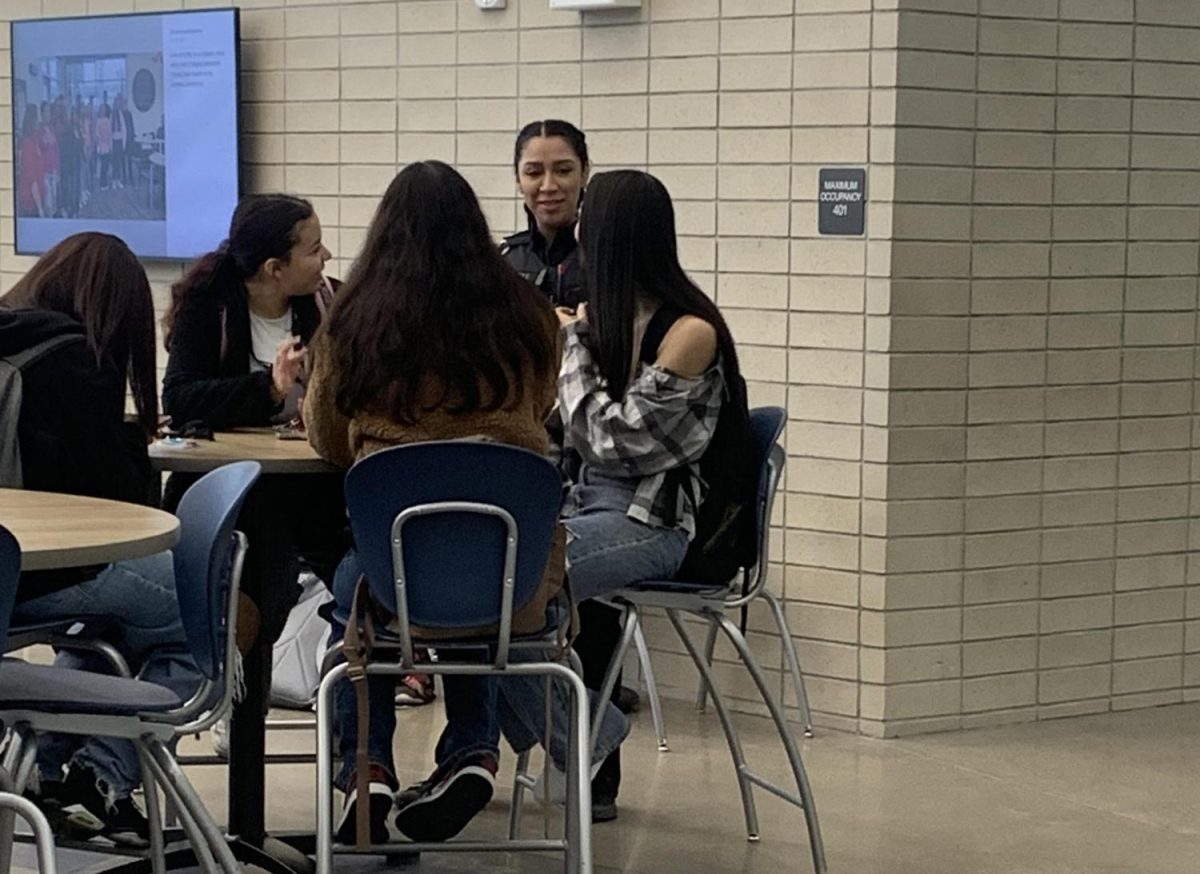 New Greeley West Student Resource officer Cyvel Diaz mingles with students in the commons during second period on Friday  
