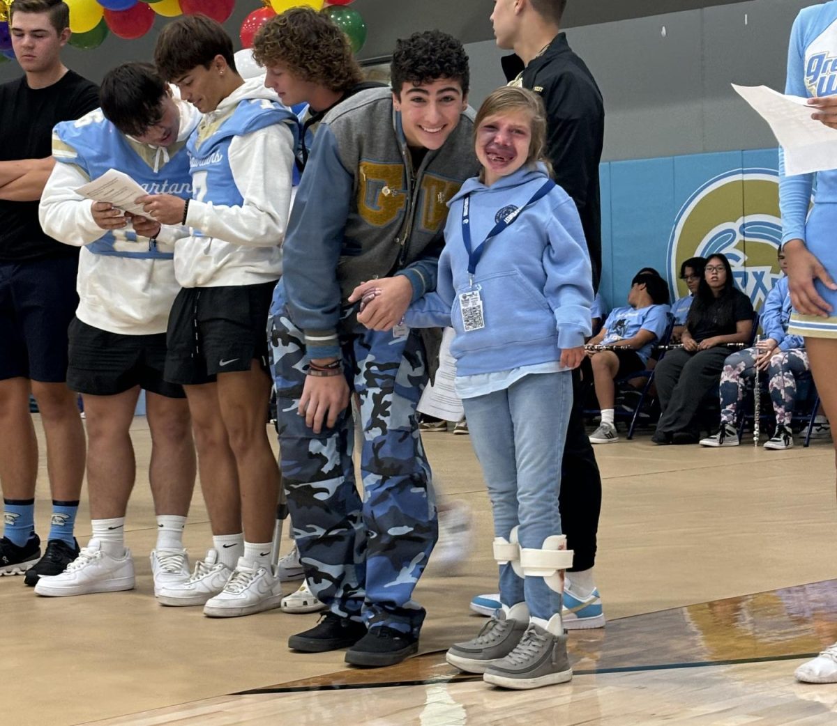 Nevaeh White takes time to smile with her friend Jeremy Piacenza after speaking at Friday's Homecoming assembly.  