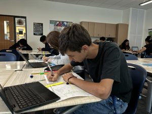 Mateo Carreno Lopez colors a map in his geography class.  