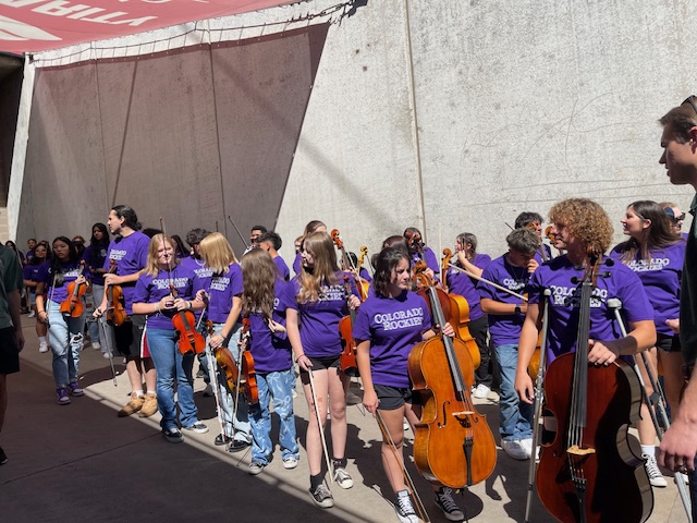 The Greeley West orchestra gets ready to take the field to play the National Anthem at Coors Field last Wednesday.