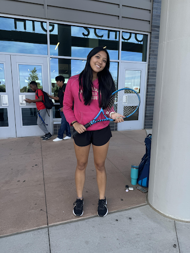 Senior Sophie Dhupar poses for a picture after tennis practice.