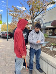 Angel Barron leads his group in figuring out measurements in downtown Greeley on Tuesday.