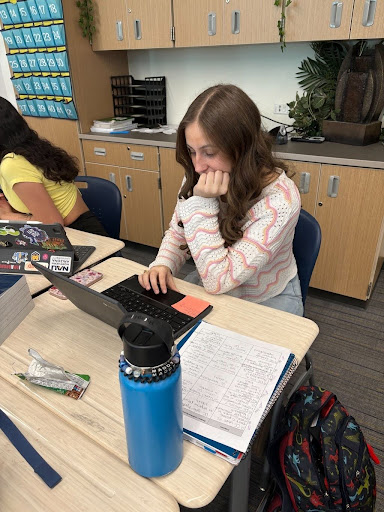 Madison Vella reads over her essay in College Composition class. 