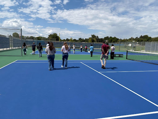 Mr. Ryan Pace joins his class on a walk on the tennis courts on Thursday.  Pace was teaching his students about stride length in relation to foot size and height. 